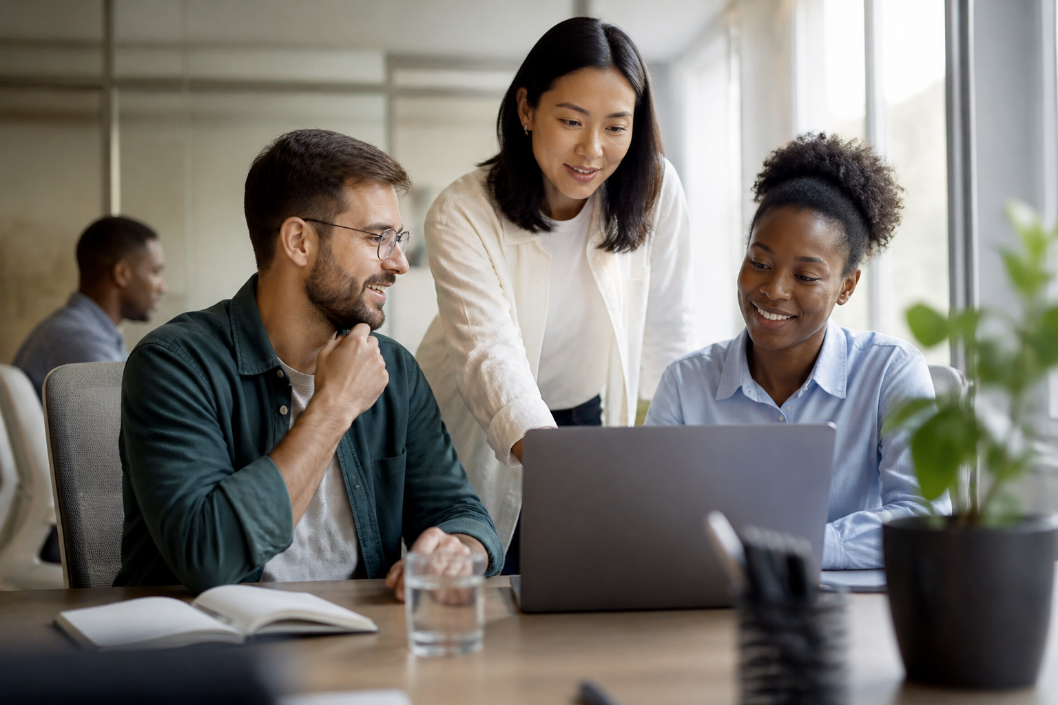 Team members collaborating in an office setting, representing employee feedback on IT systems.